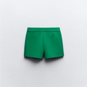 asymmetrical skort. Front false welt pocket, hidden in-seam zip closure.